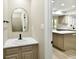 Charming half bathroom featuring a vanity with marble countertop and view to the kitchen at 6352 Watercrest Way, Indianapolis, IN 46278
