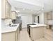 Modern kitchen with a center island, stainless steel appliances, and white countertops at 6352 Watercrest Way, Indianapolis, IN 46278