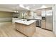 Contemporary kitchen featuring a central island and stainless steel appliances, and view of living room at 6352 Watercrest Way, Indianapolis, IN 46278