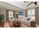 Staged living room with neutral furniture, a patterned rug, and lots of natural light at 6352 Watercrest Way, Indianapolis, IN 46278