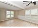 Spacious living room featuring large windows, ceiling beams, and luxury flooring at 6352 Watercrest Way, Indianapolis, IN 46278