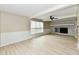 Bright living room featuring a decorative fireplace, wainscoting, and plenty of natural light at 6352 Watercrest Way, Indianapolis, IN 46278