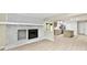 Open-concept living room with brick fireplace flows seamlessly into the updated kitchen area at 6352 Watercrest Way, Indianapolis, IN 46278