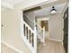 Elegant staircase with white banister and fresh flooring leading to multiple rooms of the home at 6352 Watercrest Way, Indianapolis, IN 46278