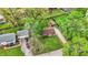 Overhead shot showcasing the property's layout, including the house, garage, driveway, and landscaped yard with mature trees at 6837 Doris Dr, Indianapolis, IN 46214