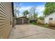 Large two car garage with a concrete patio and landscaping in the home backyard at 6837 Doris Dr, Indianapolis, IN 46214