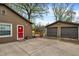 Home featuring a fenced backyard with a two car garage, back porch and red door at 6837 Doris Dr, Indianapolis, IN 46214