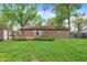 Exterior home and yard, with outdoor seating, and grass at 6837 Doris Dr, Indianapolis, IN 46214