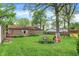 Lush backyard with play structure, storage shed, and plenty of open green space for Gathering fun and outdoor activities at 6837 Doris Dr, Indianapolis, IN 46214