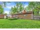 Expansive backyard featuring a shed, a lawn, and a small patio with seating, perfect for outdoor relaxation at 6837 Doris Dr, Indianapolis, IN 46214