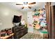 Bright bedroom with wooden dresser, flat screen TV and lots of stuffed animals at 6837 Doris Dr, Indianapolis, IN 46214
