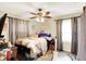 Bedroom with neutral walls, hardwood floors, and ceiling fan at 6837 Doris Dr, Indianapolis, IN 46214