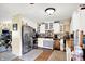 Charming kitchen featuring white cabinetry, hardwood floors, and stainless steel refrigerator at 6837 Doris Dr, Indianapolis, IN 46214