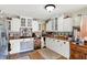 Bright kitchen showcases white cabinets, stainless refrigerator, and hardwood floors at 6837 Doris Dr, Indianapolis, IN 46214