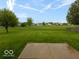 Spacious backyard with a well-maintained lawn and a concrete patio, great for entertaining at 7108 Burlat Ln, Noblesville, IN 46062