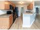 Efficient kitchen features an island, modern appliances, and wood floors at 7108 Burlat Ln, Noblesville, IN 46062