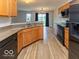 Well-lit kitchen featuring wood cabinets, modern appliances, and an undermount double sink at 7108 Burlat Ln, Noblesville, IN 46062