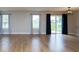 Spacious living room showcases wood floors, many windows, and sliding glass door at 7108 Burlat Ln, Noblesville, IN 46062