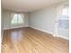 Bright living room featuring light-colored hardwood flooring and lots of natural light at 7108 Burlat Ln, Noblesville, IN 46062