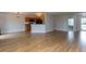 Open living area combines a kitchen and living room with wood floors and recessed lights at 7108 Burlat Ln, Noblesville, IN 46062
