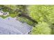 Drone view of a well manicured lawn with a covered patio area and professionally landscaped perimeter at 7653 Carriage House Way, Zionsville, IN 46077