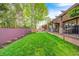 A manicured backyard with a covered patio and seating area that's perfect for relaxation and entertaining at 7653 Carriage House Way, Zionsville, IN 46077