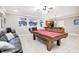 Basement area with pool table, bar, and a view into the media room with comfortable seating at 7653 Carriage House Way, Zionsville, IN 46077
