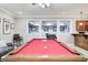 Basement recreation area with a pool table and a bar perfect for entertaining guests at 7653 Carriage House Way, Zionsville, IN 46077