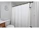Bright bathroom featuring a full shower with curtain and tiled walls, and a classic Roman numeral clock at 7653 Carriage House Way, Zionsville, IN 46077