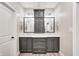 Elegant bathroom featuring a double vanity with gray cabinets, marble countertop, and stylish light fixtures at 7653 Carriage House Way, Zionsville, IN 46077