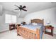 Inviting bedroom with wood frame bed, ceiling fan, and bedside tables with lamps at 7653 Carriage House Way, Zionsville, IN 46077