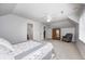 Bright, spacious bedroom with a ceiling fan, a neutral palette, and a glimpse into the adjacent bathroom at 7653 Carriage House Way, Zionsville, IN 46077