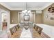 Formal dining room featuring a long wooden table and elegant chandelier at 7653 Carriage House Way, Zionsville, IN 46077