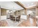 Elegant dining room with a long wooden table, rug, chandelier, and wainscoting at 7653 Carriage House Way, Zionsville, IN 46077