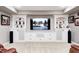 Custom built-in entertainment center with shelving and cabinets in a finished basement living room at 7653 Carriage House Way, Zionsville, IN 46077