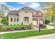 Beautiful two-story home featuring a combination of stone and brick facade with a well-manicured lawn and a two car garage at 7653 Carriage House Way, Zionsville, IN 46077