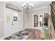 Bright foyer with hardwood floors, chandelier, and arched doorway with decorative wreath at 7653 Carriage House Way, Zionsville, IN 46077