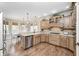 Open kitchen featuring stainless steel appliances and hardwood floors at 7653 Carriage House Way, Zionsville, IN 46077
