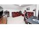 Recreation room with comfortable red leather seating, a cozy atmosphere, and a dedicated work area at 7653 Carriage House Way, Zionsville, IN 46077