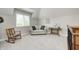 Comfortable upstairs living area with a couch, rocking chair, and bright natural light at 7653 Carriage House Way, Zionsville, IN 46077