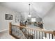 Open-concept living space with railing showcasing a bright interior, large windows, and stylish decor at 7653 Carriage House Way, Zionsville, IN 46077