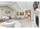 Open-concept living room with vaulted ceilings, fireplace, carpet flooring, and neutral color palette at 7653 Carriage House Way, Zionsville, IN 46077