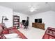 Comfortable entertainment space with red sofas, a work area, and a TV setup, perfect for relaxation at 7653 Carriage House Way, Zionsville, IN 46077