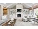 Comfortable living room with built-in shelving, fireplace, and large windows at 7653 Carriage House Way, Zionsville, IN 46077