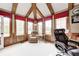 Bright office space with hardwood trim, large windows, and comfortable seating for a relaxing work environment at 7653 Carriage House Way, Zionsville, IN 46077
