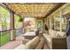 Covered patio with comfortable seating, outdoor fire pit, and view of the backyard at 7653 Carriage House Way, Zionsville, IN 46077
