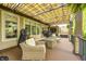 Covered patio with cozy seating, awning, gas fire pit, and exterior lighting at 7653 Carriage House Way, Zionsville, IN 46077