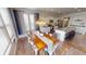 Bright dining area with wood table, white chairs, modern lighting fixture and open view of the kitchen at 7824 Gray Eagle Dr, Zionsville, IN 46077