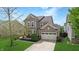 Charming two-story home featuring neutral siding, a two-car garage, and a cozy front porch at 7824 Gray Eagle Dr, Zionsville, IN 46077