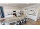 Modern kitchen with white cabinets, stainless steel appliances, and a large island with a granite countertop at 7824 Gray Eagle Dr, Zionsville, IN 46077